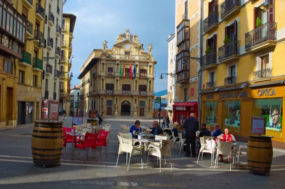 PAMPLONA, SPAIN, OCTOBER 25, 2014: People are having lunch in a restaurant in front of the town hall in spanish city pamplona.