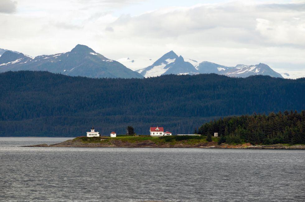 A marine highway ferry boat passes a nautical beacon on the inside passage.