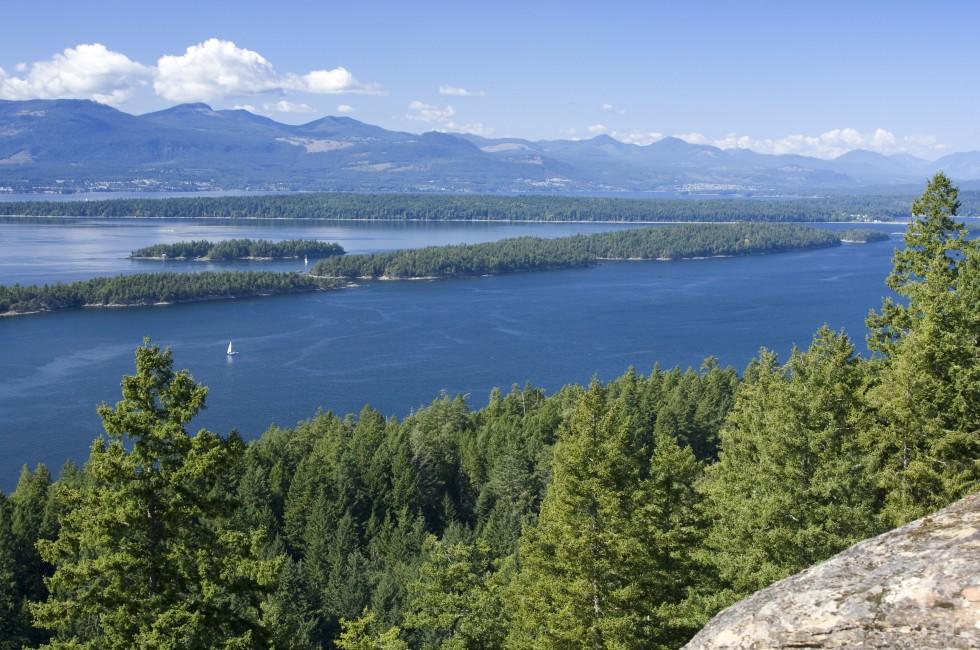 From a rocky outcrop on Bodega Ridge, Galiano Island, BC, one has a view of blue water, green treed islands, and the mountains of Vancouver Island.; Shutterstock ID 20815561; Project/Title: Fodor's Top 100; Downloader: Fodor's Travel