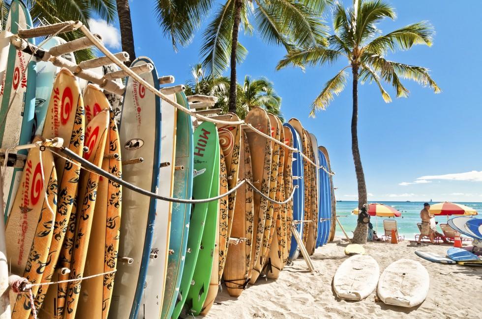 HONOLULU, HAWAII - SEPTEMBER 7, 2013: Surfboards lined up in the rack at famous Waikiki Beach in Honolulu. Oahu, Hawaii.