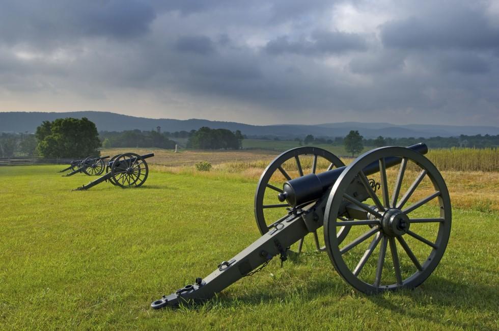 Morning storm clouds over a row of cannon at Antietam Battlefield at Sharpsburg, Maryland, USA.