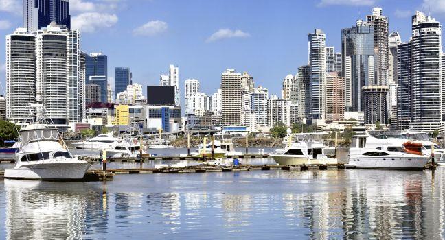 Modern city view - skyscrapers and luxury yachts with water reflection - Panama City;