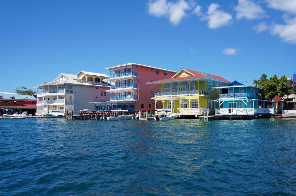 Colorful Caribbean buildings over the water with boats at dock, Colon island, Bocas del Toro, Panama