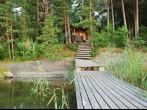 small forest lake with bridge in Lakelands region of Finland