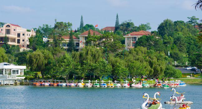People sail on catamarans at Xuan Huong Lake. This artificial lake in the city centre is a favourite place for tourists and locals for walking.