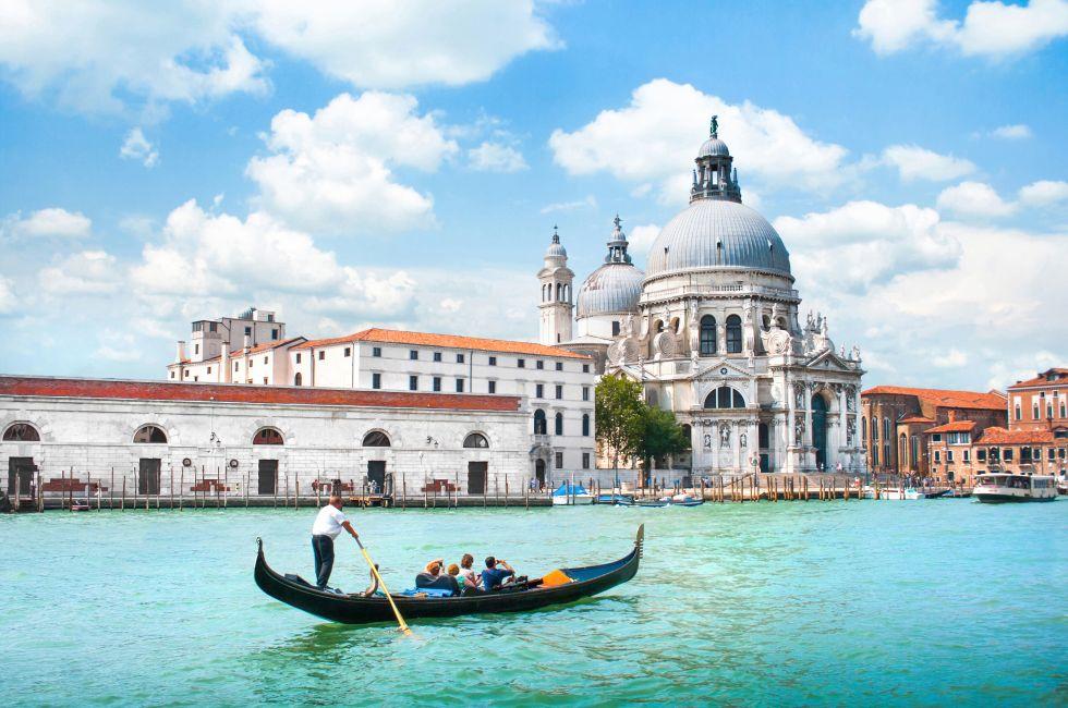 Traditional Gondola on Canal Grande with Basilica di Santa Maria della Salute in the background, Venice, Italy.