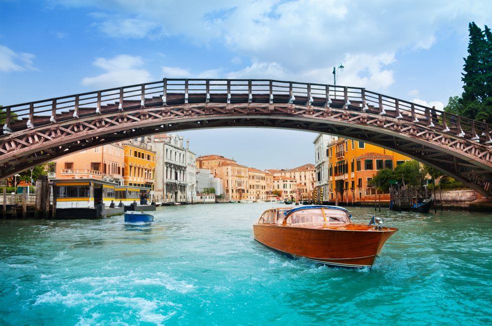 Ponte dell'Accademia in Venice and motorboats on grand canal in Venice.