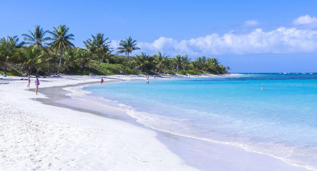 CULEBRA, PUERTO RICO - JANUARY 21, 2014: Vacationers enjoy the clear blue water and warm sunshine on one of the world's best beaches, Flamenco Beach, on the Puerto Rican island of Culebra